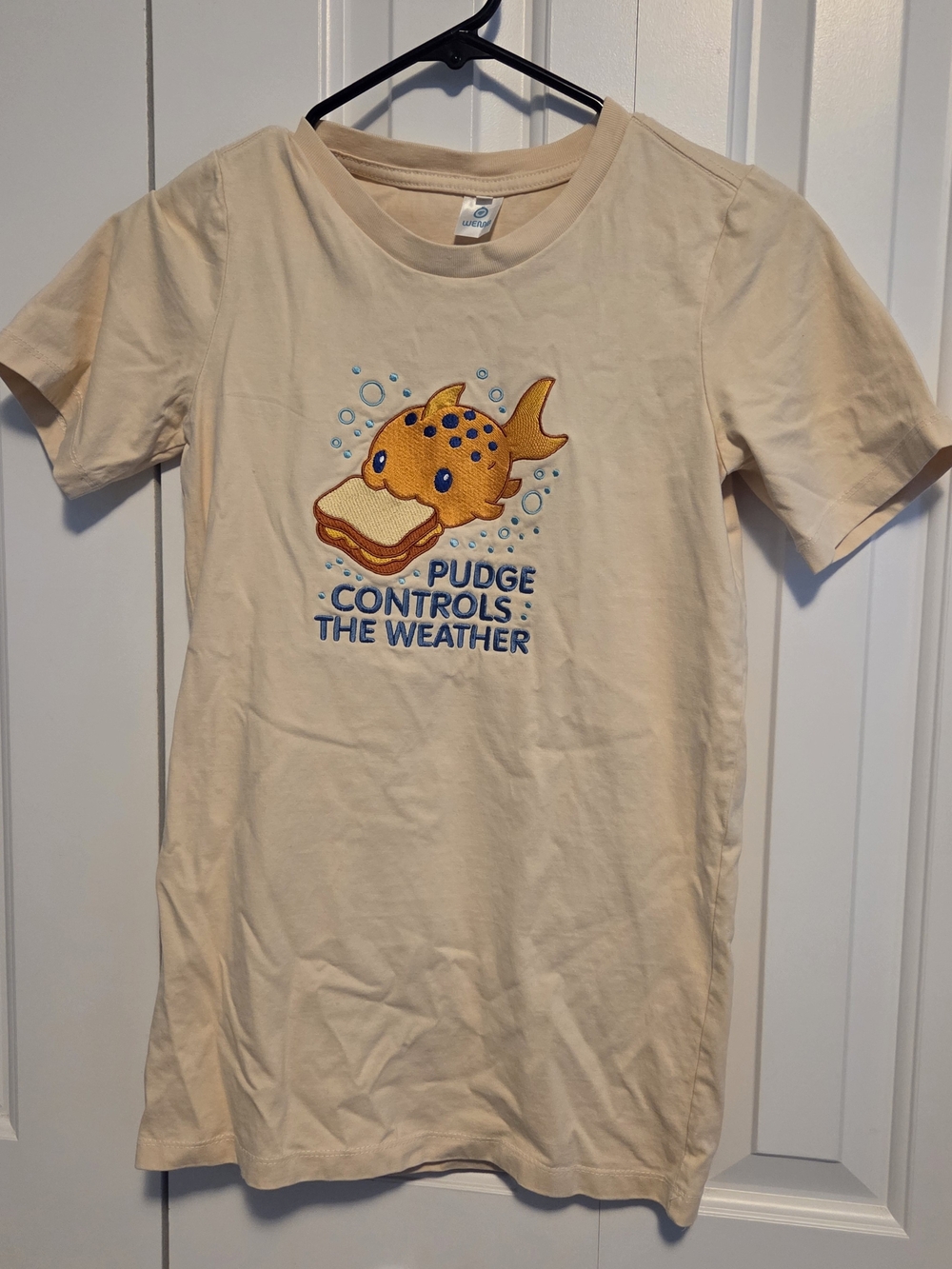 Cream Graphic Tee with Yellow Fish Patch - Pudge Controls the Weather